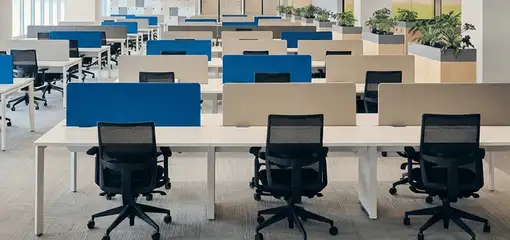 Modern open-plan office space featuring clean workstations, ergonomic chairs, and sanitized carpets provided by professional office cleaning services in Aurora, IL.