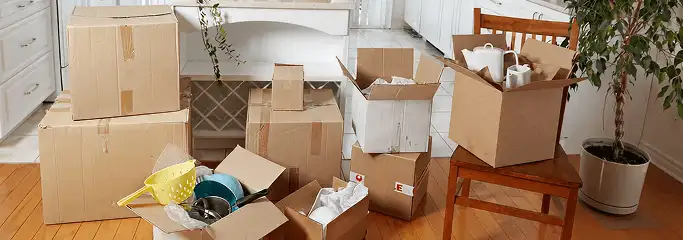 Packed moving boxes and household items in a kitchen before move-out or move-in cleaning, Aurora, IL.
